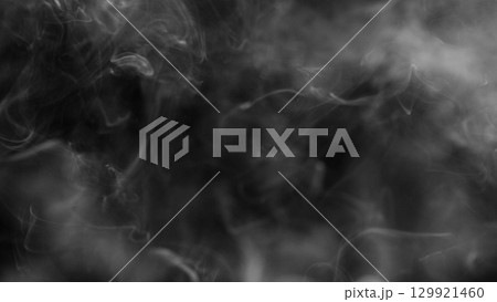 Detail Shot of Atmospheric Smoke Slowly Floating on Black Background 129921460