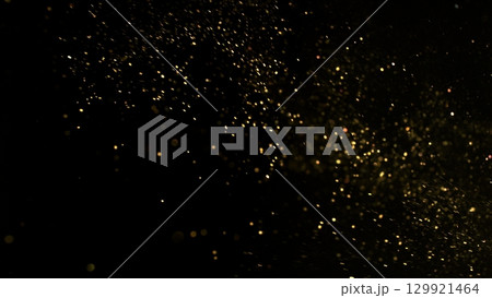Freeze Motion Shot of Golden Glitter Background Isolated on Black 129921464