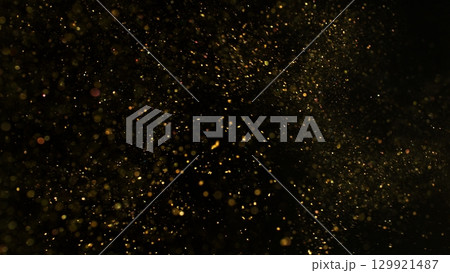 Freeze Motion Shot of Golden Glitter Background Isolated on Black 129921487