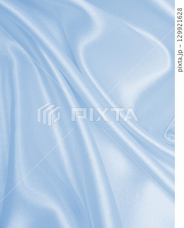 Smooth elegant blue silk or satin luxury cloth texture as abstract background. Luxurious background design 129921628