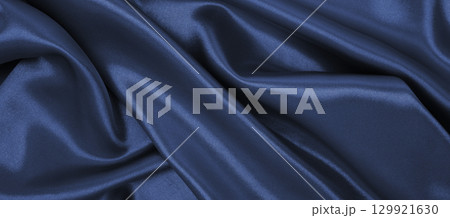 Smooth elegant dark grey silk or satin luxury cloth texture as abstract background. Luxurious background design Smooth elegant dark grey silk or satin luxury cloth texture as abstract background. Luxurious background design 129921630