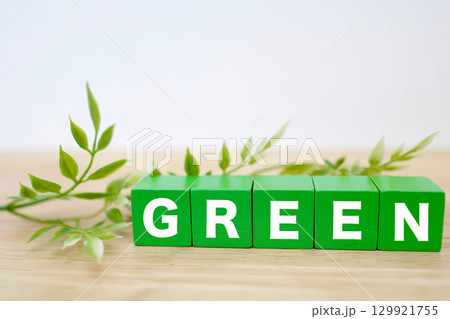 緑色のブロックに並んだGREENの文字と葉の背景	 129921755