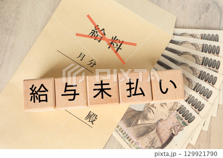 給与未払い問題を表現したイメージ写真と日本円札 給与未払い問題を表現したイメージ写真と日本円札 129921790