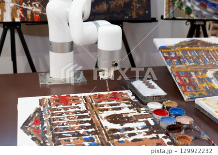 Robot creating artwork using paint on canvas, symbolizing fusion of artificial intelligence and creativity. Perfect representation of AI role in modern art and creative industries 129922232
