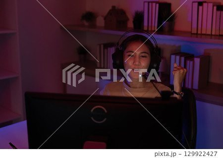 Joyful Gamer Celebrating Win in Home Office 129922427