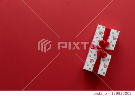 Christmas gift on a red background. Top view 129923002