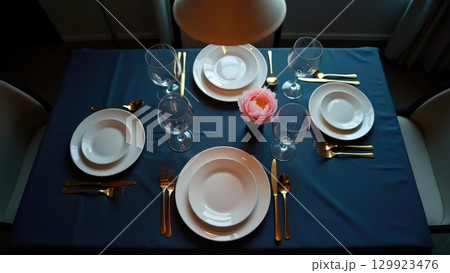 Elegant Minimalist Dinner Party Table Setting Awaiting Guests Overhead Elegant Minimalist Dinner Party Table Setting Awaiting Guests Overhead 129923476