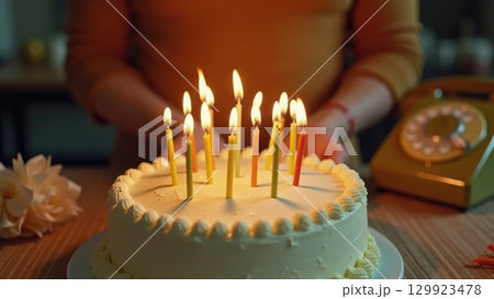 Vintage 1970s Birthday Celebration Hands Blowing Out Candles on Cake 129923478