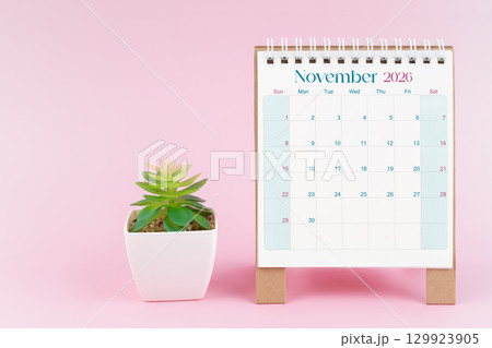 Desk calendar for November 2026 with plant pot on a pink color background. Desk calendar for November 2026 with plant pot on a pink color background. 129923905