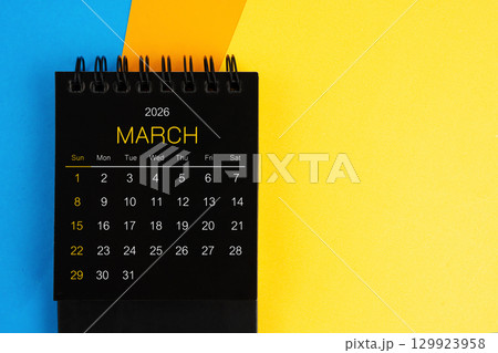 Black mini calendar for March 2026 on multi color background. 129923958