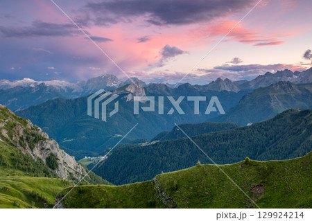 Stormy Evening Sky Over Green and Rocky Peaks 129924214