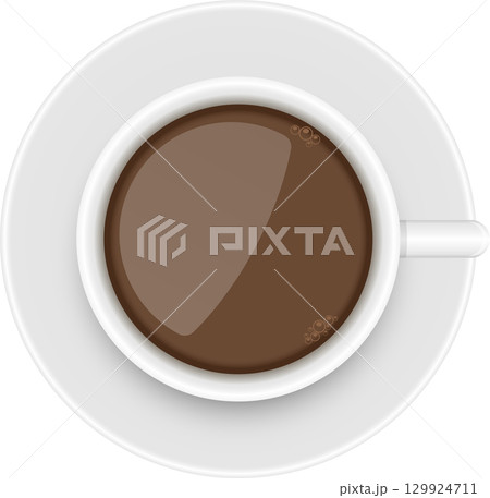 Overhead shot of a white cup and saucer filled with a rich brown drink with small bubbles. 129924711