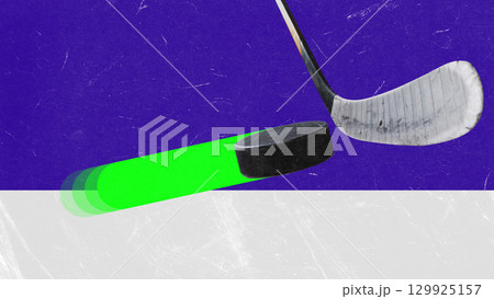 Creative collage. Hockey puck with neon glowing trail near stick on ice surface 129925157