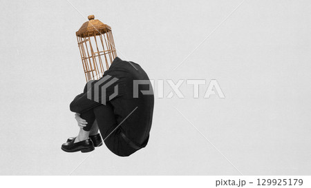 Creative collage. Person curled with birdcage instead of head expressing loneliness 129925179