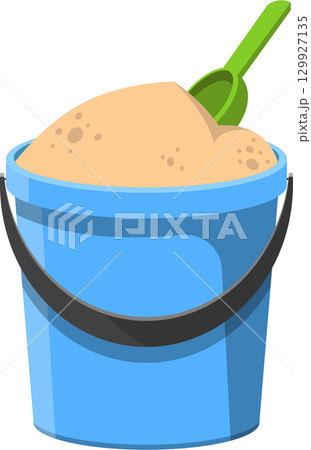 A blue bucket is filled with sand and a green shovel, inviting imaginative play and fun. 129927135