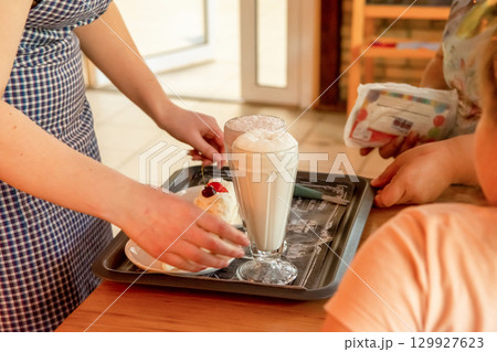 Ordering desert at a cafe at a meeting of friends during a lunch break to discuss important 129927623