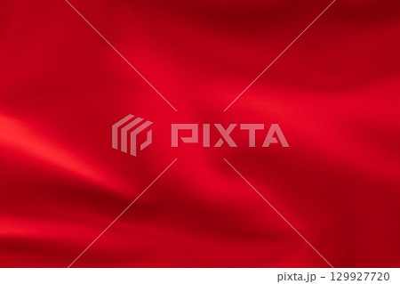 Bright red fabric with soft folds, textile texture close-up 129927720