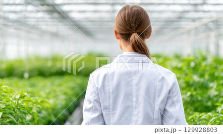 Woman in White Lab Coat in Greenhouse 129928803