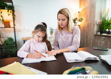 Learning together at a cozy study table during an afternoon session 129928992