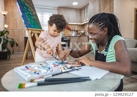 Creative bonding between a mother and child in a cozy studio Creative bonding between a mother and child in a cozy studio 129929127