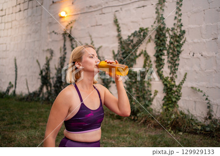 Mother engages in postnatal fitness routine to regain confidence outdoors 129929133