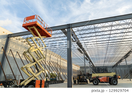 Industrial warehouse construction site. Assembling of metal and concrete frame of new logistics center in North Port, Florida 129929704