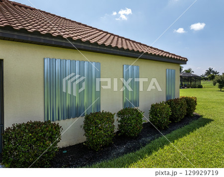 Hurricane shutters on Florida house windows. Home protection before natural disaster 129929719