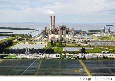 Aerial view of sustainable energy development at Florida Big Bend Power Station. Solar panels symbolize the shift from traditional fossil fuels to clean, emission-free electricity production 129929804