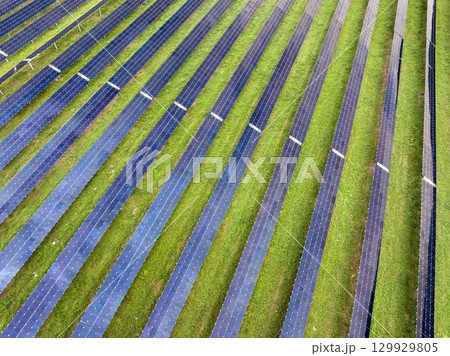 Solar power plant with many rows of photovoltaic panels for producing clean electrical energy. Concept of renewable electricity with no air pollution 129929805