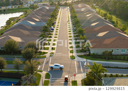 Expensive mansions between green palm trees in southwest Florida suburbs, USA. Aerial view of wealthy residential neighborhood 129929815