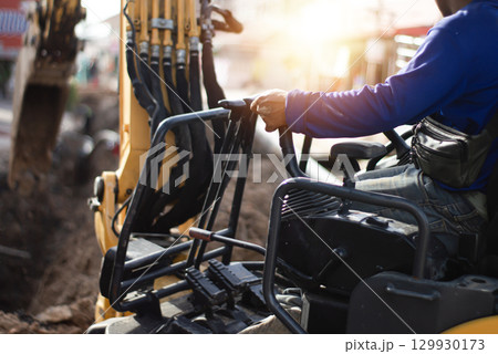 The excavator driver is controlling the operation of the vehicle. The excavator driver is controlling the operation of the vehicle. 129930173
