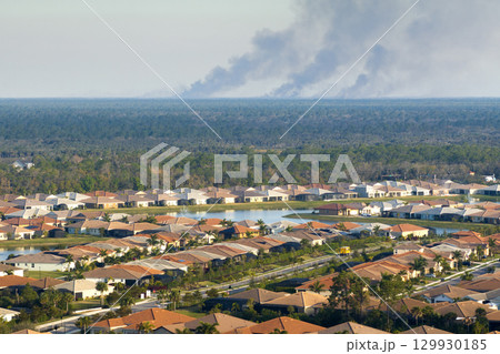 Suburban neighborhood in Florida suffering from bad air quality polluted with prescribed forest fire smoke 129930185