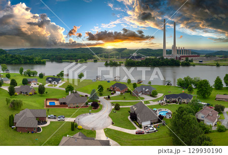 Thermal power plant polluting air burning coal fossil fuel for production of electrical energy. Private residential houses at Kingston power station in Roane County, Tennessee 129930190