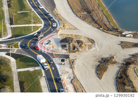 Industrial roadworks. Roundabout on wide American highway under construction. Development of transportation system for rapid transit Industrial roadworks. Roundabout on wide American highway under construction. Development of transportation system for rapid transit 129930192