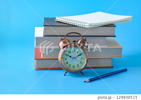 Alarm clock with books.back to school concepts. Alarm clock with books.back to school concepts. 129930515