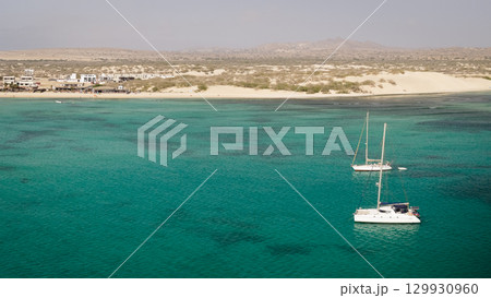 Aerial view of the luxury yacht moored in turquoise ocean background the desert Aerial view of the luxury yacht moored in turquoise ocean background the desert 129930960