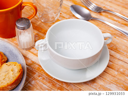 Dishes are prepared for meals on wooden table. 129931033