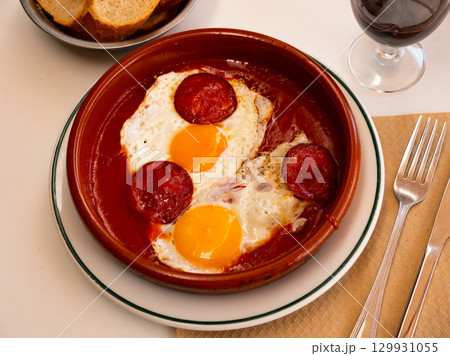 Spanish tapas with chorizo sausage and tomato paste closeup Spanish tapas with chorizo sausage and tomato paste closeup 129931055