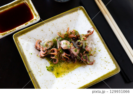 Small fried octopus with soy sauce. Japanese dish close up 129931066