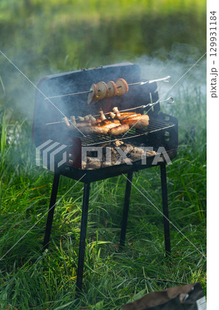 Mobile barbecue on the forest river bank. 129931184