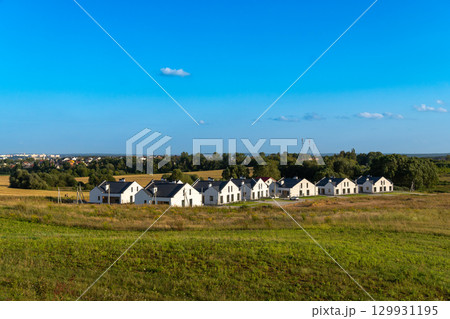 View of newly built modern suburban houses in a quiet residential area. 129931195