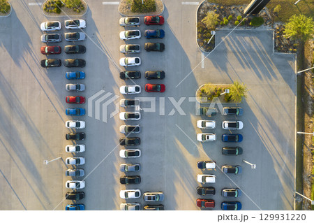 Large parking lot of local dealer with many brand new cars parked for sale. Development of american automotive industry and distribution of manufactured vehicles concept 129931220