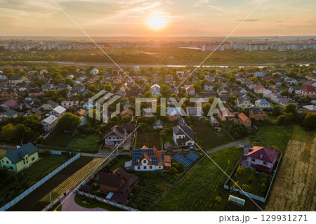 Aerial view of residential houses in suburban rural area at sunset Aerial view of residential houses in suburban rural area at sunset 129931271
