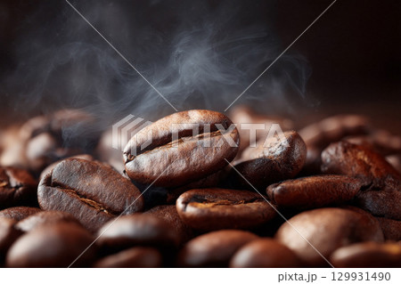 Rich coffee beans with steam rising in a warm atmosphere showcase fresh brewing process 129931490