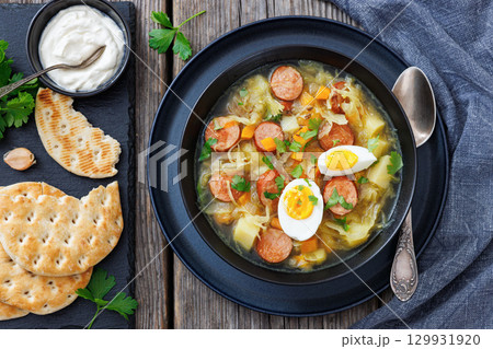 Polish sauerkraut soup with sausage in a bowl Polish sauerkraut soup with sausage in a bowl 129931920