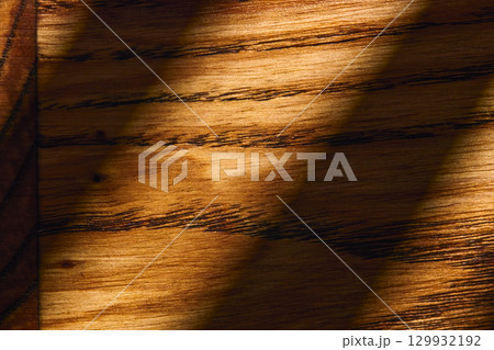 A close-up view of beautifully grained wood reveals rich, warm tones and smooth textures. 129932192