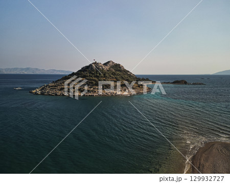 Aerial view of small islet with Turkish flag and sand spit, Aegean Turkey 129932727