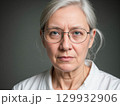 Serious Portrait of a Middle-Aged Woman with Glasses 129932906