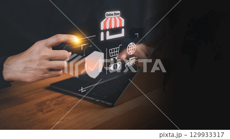 Customer holding a credit card while using a laptop with virtual shopping icons. Business concept of secure online transactions, e-commerce, digital payments, and modern financial technology systems. 129933317