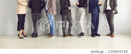 Legs of different business people standing in row and communicating with each other. Legs of different business people standing in row and communicating with each other. 129934148